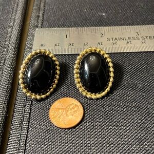 Vintage signed Monet classic black and gold clip on earrings. Preowned